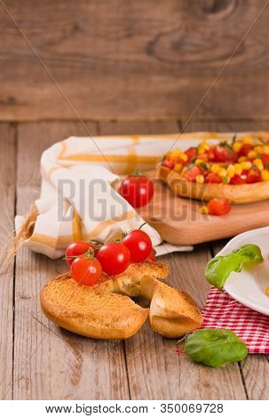 Friselle With Tomatoes And Mais On White Dish.