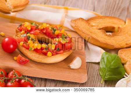 Friselle With Tomatoes And Mais On White Dish.