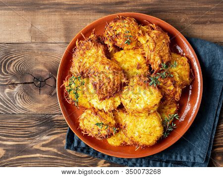 Potatoes Pancakes Latkes, Flapjacks, Hash Brown Or Potato Vada On Brown Wooden Table. Top View Or Fl