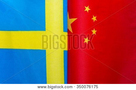 Fragments Of National Flags Of The Kingdom Of Sweden And China Close-up