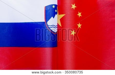 Fragments Of National Flags Of The Republic Of Slovenia And China In Close-up