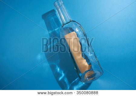 blank massage in a botol on the blue background