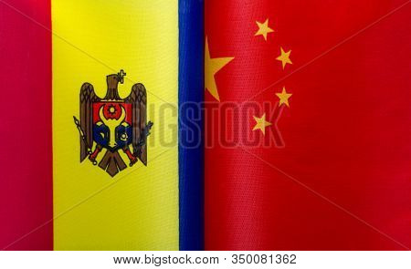 Fragments Of National Flags Of The Republic Of Moldova And China In Close-up