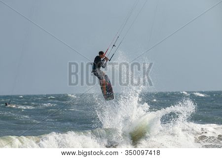 Kitesurfing on the waves of the sea in Mui Ne beach, Phan Thiet, Binh Thuan, Vietnam. Kitesurfing, Kiteboarding action photos Kitesurfer In action