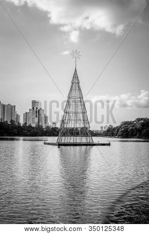 Black And White Photo Of A Floating Christmas Tree At A Lake, Made With A Steel Structure And Christ