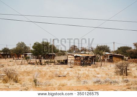 Shacks Outside In The Desert Between Sand And Bushes In Africa