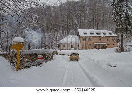 The Car Rides On A Snowy Mountain Road