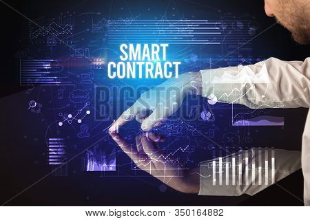 Businessman touching huge screen with SMART CONTRACT inscription, cyber business concept