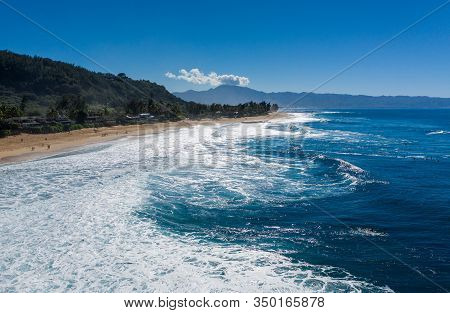 Surfers Waiting For The Big Wave In The Sea At Banzai Pipeline On North Coast Of Oahu, Hawaii
