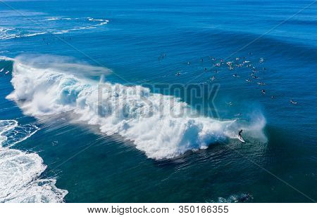 Surfers Waiting For The Big Wave In The Sea At Banzai Pipeline On North Coast Of Oahu, Hawaii
