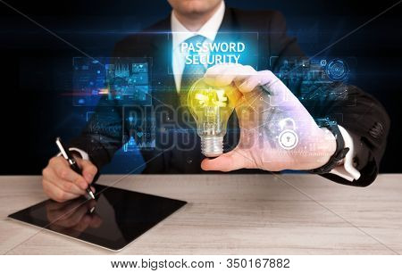 Businessman holding lightbulb with PASSWORD SECURITY inscription, online security idea concept