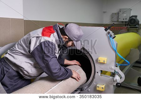 Men Workers Get Carpet From An Automatic Washing Machine And Put In In Dryer In The Laundry Service