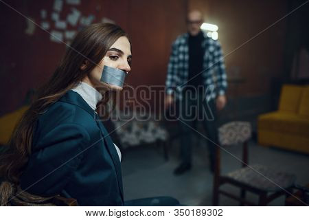 Maniac kidnapper and victim with taped mouth shut