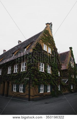 Ivy Covered Fuggerei House In Augsburg, Bavaria In Germany