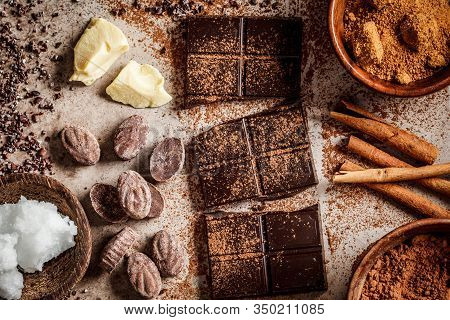 Ingredients For Making Chocolate Background. Cocoa, Cocoa Butter, Sugar, Cinnamon And Coconut Oil On