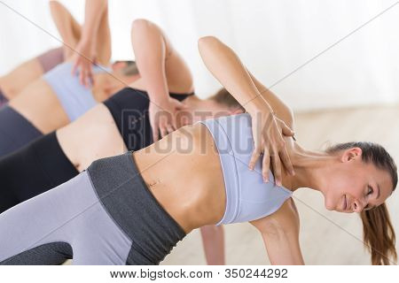 Group Of Young Sporty Attractive Women In Yoga Studio, Practicing Yoga Lesson With Instructor, Formi