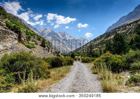 Turkey, Chamard - August 3, 2019: Tourists Walk Along The Road Through The Mountain Landscape In The