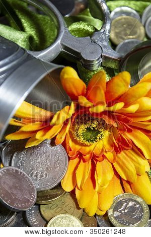 Hinge And Handle Of The Tin Cup In Background Focus, With Orange Fabric Flower