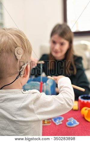 A Boy With Cochlear Implants Playing With His Mother