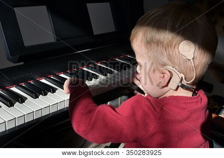 A Boy With Cochlear Implants Playing Piano