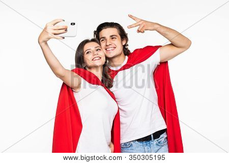 Young Couple Hero In Red Cout Take Selfie On The Phone Isolated On White Background
