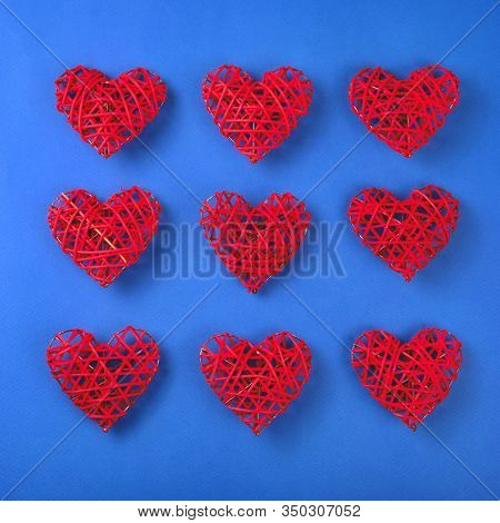 Beautiful Pattern Of The Red Wicker Hearts On The Cornflowerblue Background. St Valentines Concept F