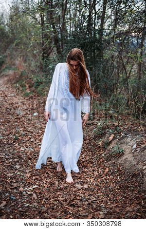 Outdoor Portrait Of Beautiful Girl In White Nightgown, Walking Barefoot. Retro Vibes