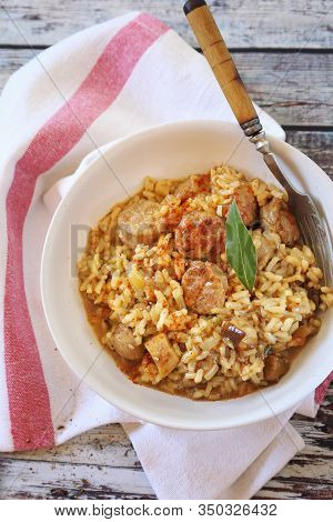 Regional Italian Cuisine. Piedmontese Risotto With Porcini Mushrooms And Sausages. Rustic Style, Top