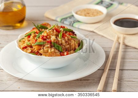 Tori Chahan Fried Japanese Rice With Vegetables And Chicken In Soy Sauce In A Black Plate On A Woode