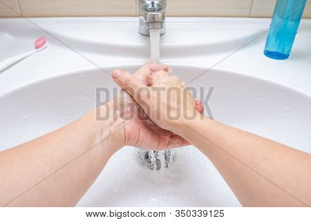 Woman Washing Hands Under The Faucet With Water, Hygiene And Profilactics Concept.