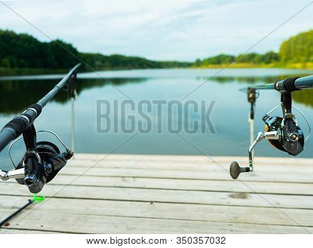 Carp Fishing On Beautiful Blue Lake With Carp Rods And Rod Pods In The Summer Morning. Fishing From 