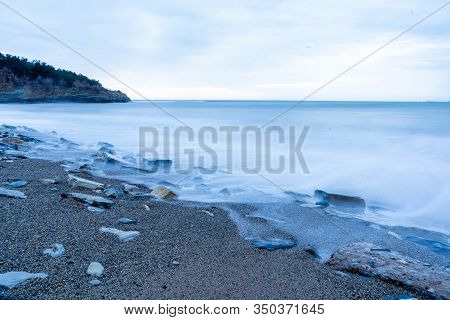 Storm Surges At Slow Shutter Speeds On A Pebble-sandy Beach, The Resort Of Gelendzhik, The Twilight.