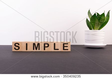 Simple, Simplicity Make Things Clear And Easy To Manage Concept, Cube Wooden Block With Alphabet Com
