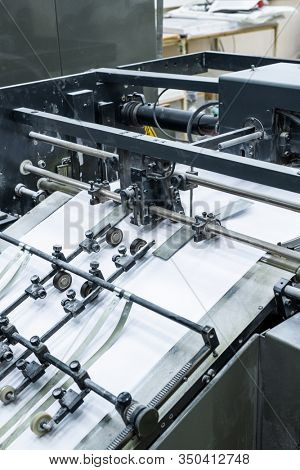 Process of printing at factory: close-up of linotype machine using technology for typesetting text