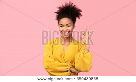 Im Fine. Happy Black Girl Showing Approval Ok Gesture And Smiling Isolated Over Pink Studio Wall, Co