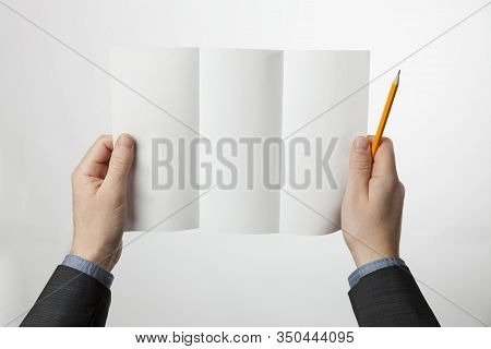 Tri-fold Paper Brochure In Hands. Z-fold Design Blank For Marketing Or Advertising.