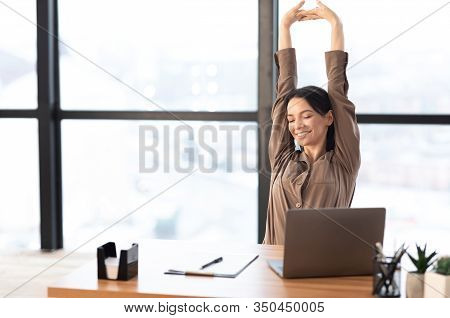 Good Morning. Happy Female Manager Stretching Her Body And Arms Working At Home Or Modern Office, Co