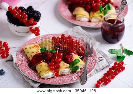 Crepes With Lemon Cream And Raspberry Jam..selective Focus. Style Vintage