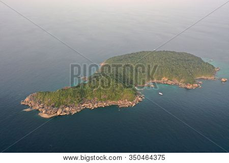 Aerial photo of scuba dive liveaboard boat beside tropical island