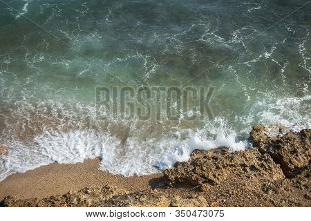 Waves Of The Sea Reaching The Shore Of The Beach