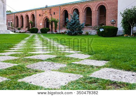 Green Garden With Clean Grass In The Churchyard.