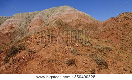 Beautiful View Of The Red Mountain. Natural Elevation In The Steppe.