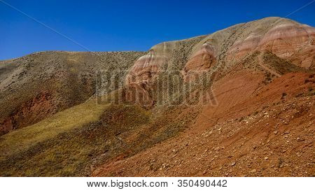Beautiful View Of The Red Mountain. Natural Elevation In The Steppe.