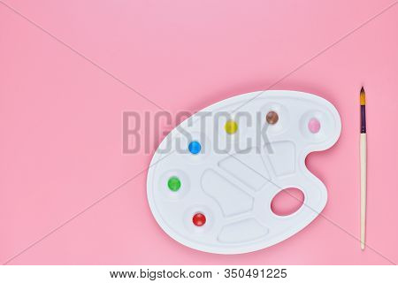 Art Of Sweetmeats Concept, Copy Space. Sweet Candy In Paint Palette On Pink Background. Love To Colo