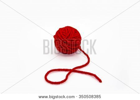 Red Skein Of Thread Against White Background. Red Ball Of Wool Red Thread Isolated On White
