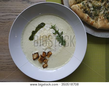 Cheese Cream Soup With Crutons. In A Deep Plate, Sprinkled With Parmesan, A Sprig Of Greens