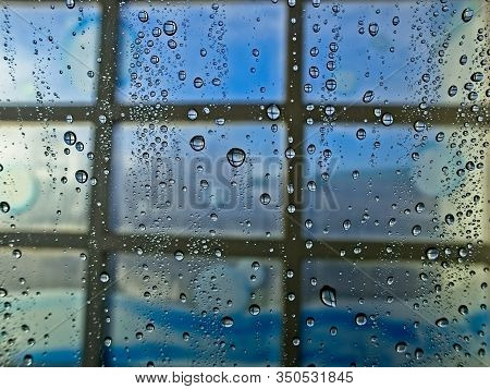 Water Droplets On Window In Car Wash On Sunny Day In Blue Tone