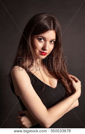 Portrait Of Beautiful Brunette Woman In Black Dress. Fashion Photo.