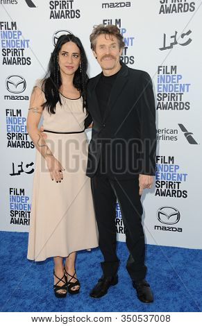 Giada Colagrande and Willem Dafoe at the 35th Annual Film Independent Spirit Awards held at the Santa Monica Beach in Santa Monica, USA on February 8, 2020.