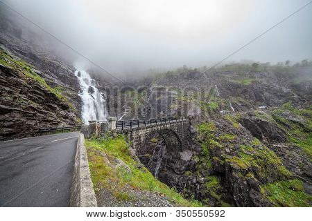 Trolls Path Trollstigen Or Trollstigveien Scenic Mountain Road In Norway Europe. Waterfall And Bridg